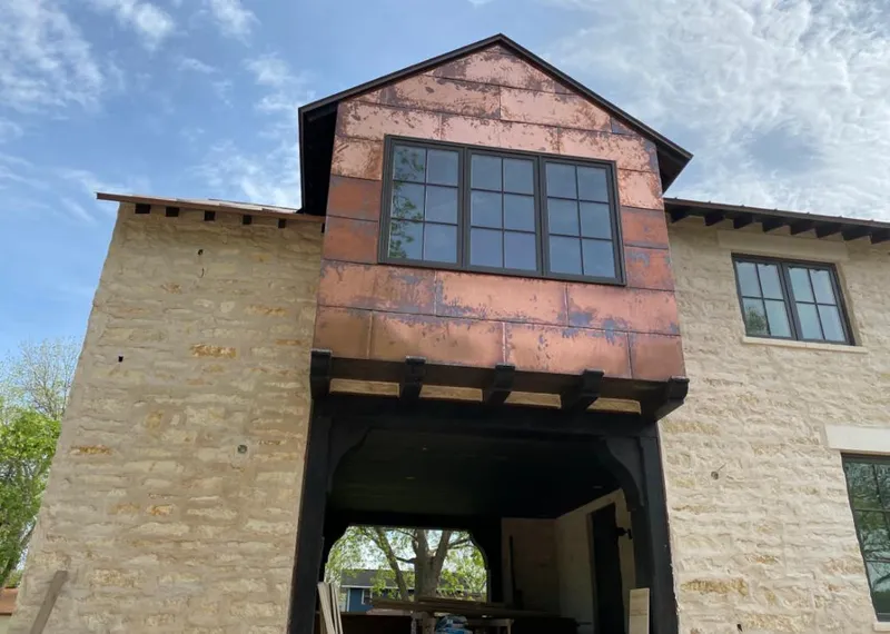 Copper metal panel facade on a stone building for Skylight Installation in Finneytown